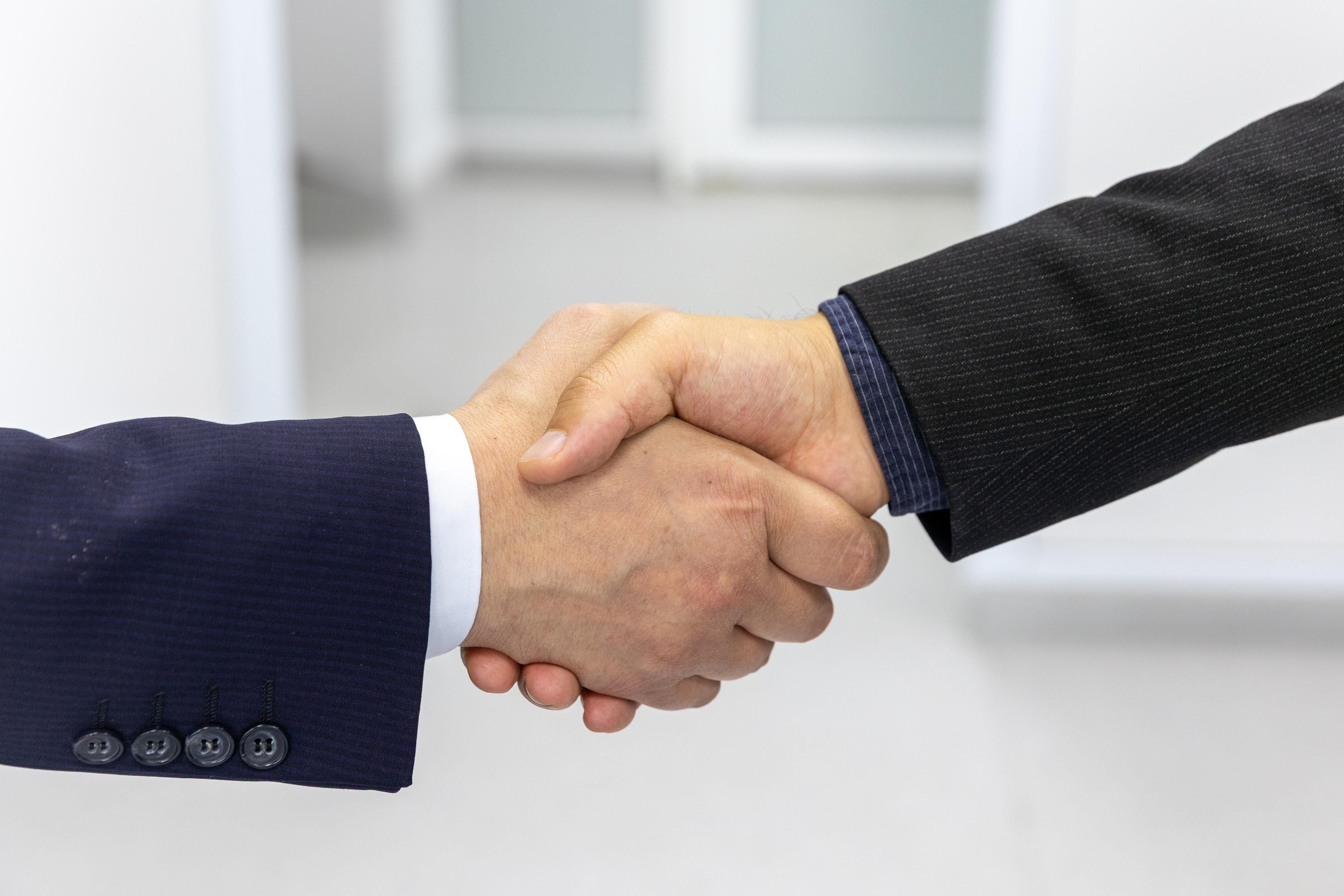 Two people shaking hands.
